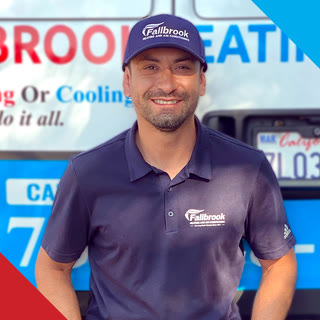 Jessie, a Fallbrook Heating and Air Conditioning technician, in front of a company van