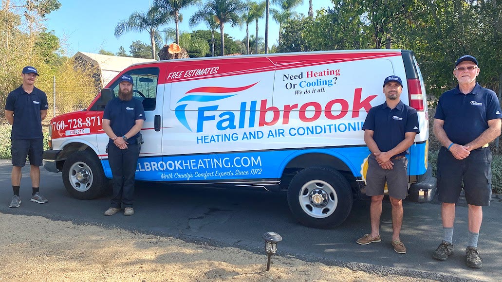 The Fallbrook Heating and Air Conditioning team standing with a company service van